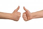 stock photo of teamwork  - Two male hands showing thumbs up sign against white background - JPG 
