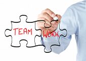 pic of puzzle  - Human hand drawing teamwork puzzle concept on the whiteboard - JPG 