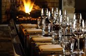 foto of restaurant  - a long table is set at a restaurant by the fire - JPG 