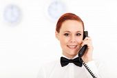 picture of receptionist  - pretty young receptionist working at hotel reception - JPG 