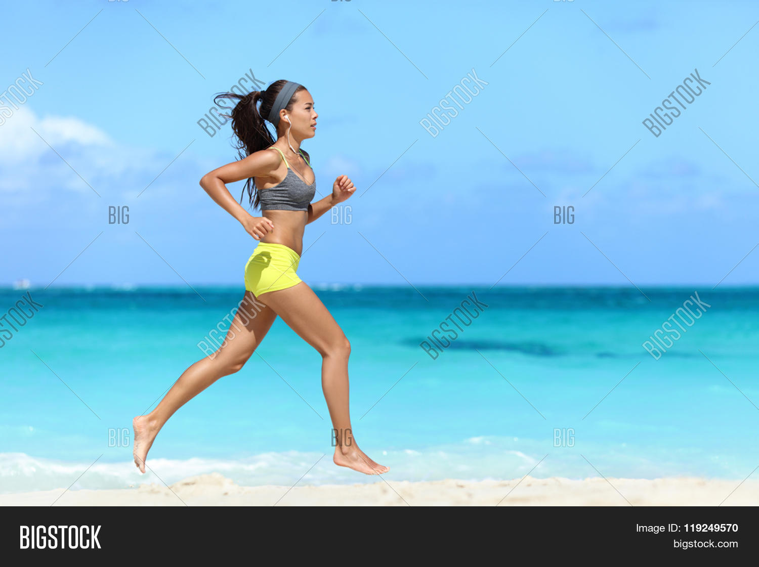 Fit Female Athlete Runner Running On Beach Full Length Body Fit Female Athlete Runner Running On Beach Full Length Body Of Woman Jogging Fast