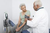pic of pressure  - Senior doctor measuring patient - JPG 
