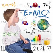 foto of science  - A young boy child is writing out math and science equations and formulas - JPG 