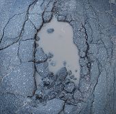 pic of transportation  - Pot hole or pothole image of a broken cracked asphalt pavement with a dirty water puddle as a transportation symbol of road maintenance and the car insurance risk to auto suspensions - JPG 