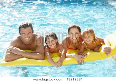 Picture or Photo of Young family, parents with children, in pool