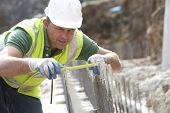 stock photo of construction  - Construction Worker Holding Measure - JPG 