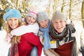 stock photo of family  - Family Having Fun Snowy Woodland - JPG 