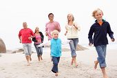 picture of family  - Three Generation Family Running Along Winter Beach Together - JPG 