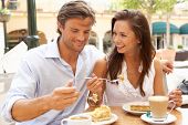 pic of restaurant  - Young Couple Enjoying Coffee And Cake In Cafe - JPG 