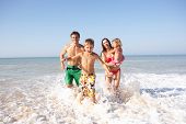 foto of beach  - Young family play on beach - JPG 