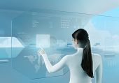 stock photo of future technology  - Future technology touchscreen interface.
Girl touching screen interface in hi-tech interior.
Business lady pressing virtual button in futuristic office. - JPG 