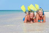 foto of beach  - Senior Couple With Snorkels Enjoying Beach - JPG 