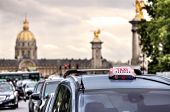 stock photo of france  - Parisian taxi illuminated sign on the car roof and Les Invalides on the background in Paris - JPG 