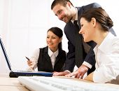 pic of meeting  - Portrait of executive employees looking at laptop monitor and discussing new project - JPG 