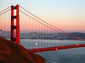 stock photo of golden gate bridge  - a lone sailboat sailing near the golden gate bridge - JPG 
