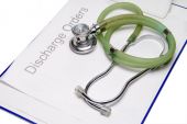 stock photo of discharge  - Medical discharge papers with a doctors stethoscope - JPG 