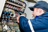 pic of wire  - One electrician working on a industrial panel mounting - JPG 