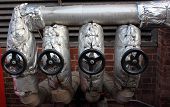 stock photo of lag  - A row of lagged isolating valves going into the blowdown vessel outside of a steam boiler house - JPG 