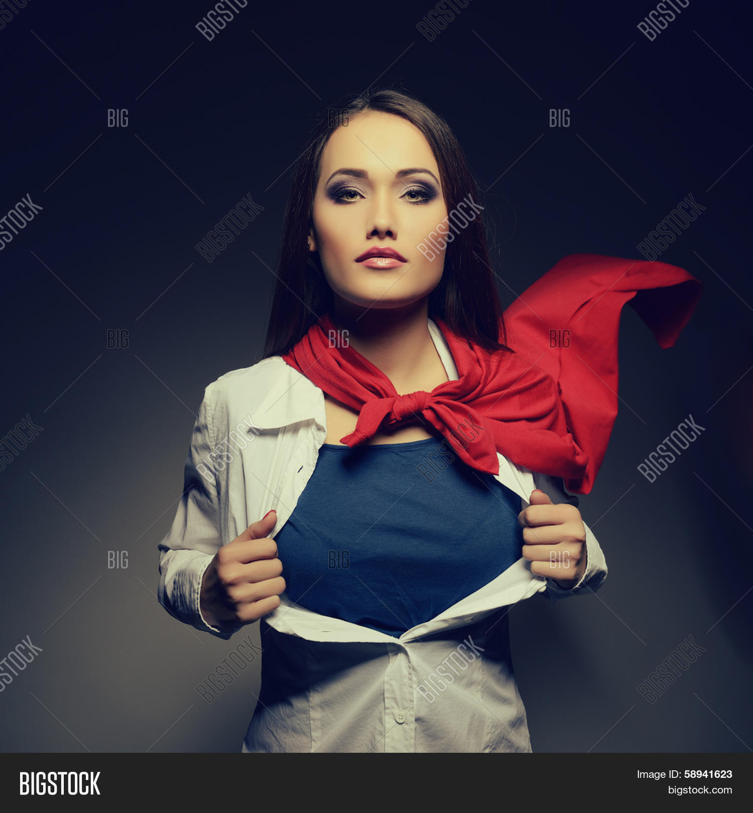 Young pretty woman opening her shirt like a superhero. Super girl