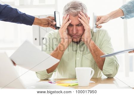 Overwrought businessman with hands on head at the office