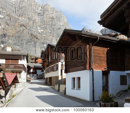Old street  with typical swiss house in Leukerbad, Canton of Valais in Switzerland.