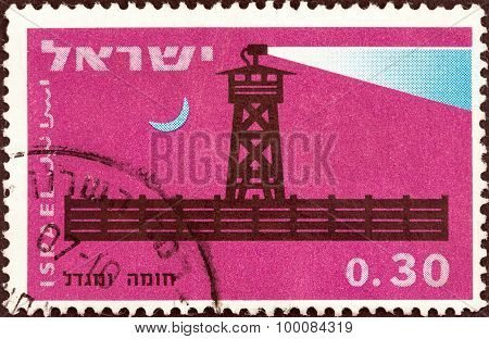 ISRAEL - CIRCA 1963: A stamp printed in Israel shows Completed stockade at night