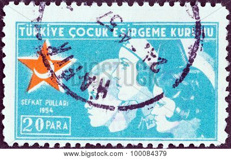 TURKEY - CIRCA 1954: A stamp printed in Turkey shows a nurse with two children