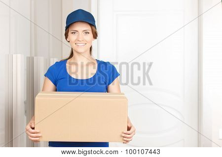Nice deliverywoman standing near door
