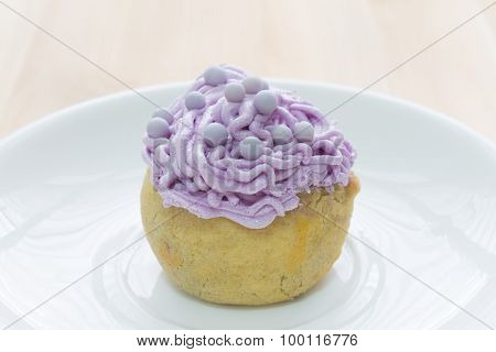 Purple Choux Or Profiterole Or Eclair On Wood Table