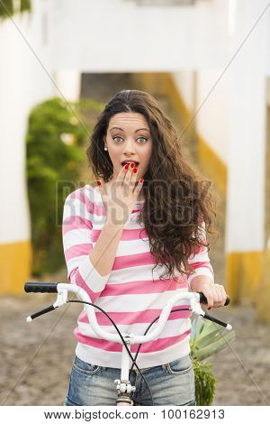 Happy beautiful girl riding her bicycle 