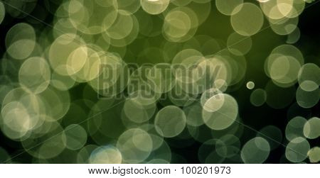 picture of a bokeh of  Shinig waterdrops against morning light