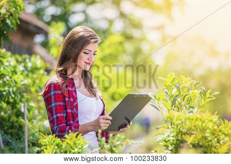 Beautiful young woman gardening