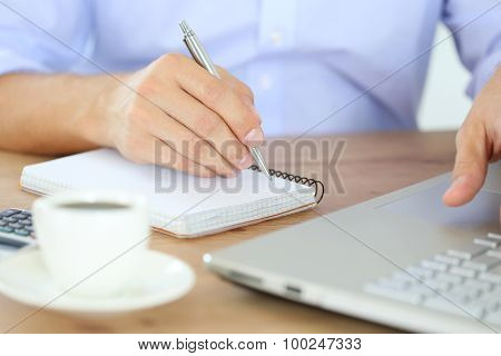 Male Hand Holding Silver Pen
