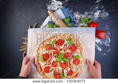Closeup hand of baker making pizza at kitchen