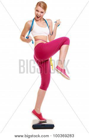 Woman Clenching Fists Measuring On Weighing Scale.