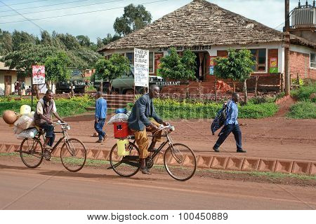 African Peasants Transported Cargo On Road Bikes.
