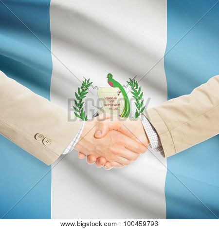Businessmen Handshake With Flag On Background - Guatemala
