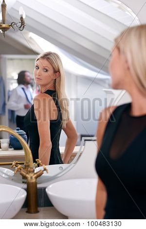 young professional business woman checking elegant dress in mirror reflection at home bedroom
