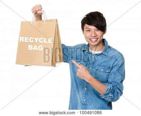 Man finger point to shopping bag for showing phrase of recycyle bag