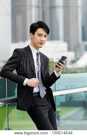 Businessman hold with cellphone at outdoor