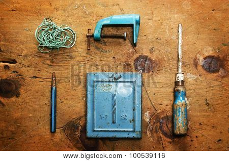 Vintage wood table with drill, screwdriver, clamp, plummet and rope.