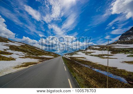 VALDRES, NORWAY - 6 JULY, 2015: Beautiful road passing through Valdresflya mountain range sorrounded