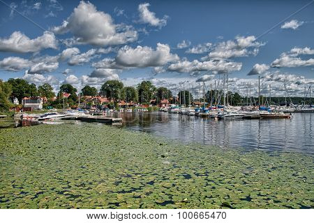 Puffy clouds blue sky above a town on Malaren lake Sweden