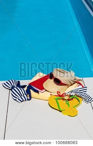 utensils for a nice relaxing vacation day lying next to a swimming pool. relaxation on vacation.