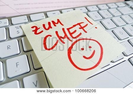 a memo is on the keyboard of a computer as a reminder: for chef