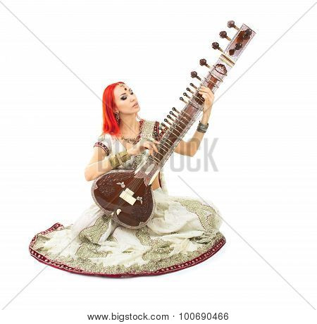 Beautiful Redhead Woman In Indian Sari With Oriental Jewelry Playing The Sitar