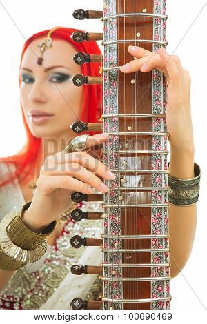 Beautiful Redhead Woman In Indian Sari With Oriental Jewelry Playing The Sitar