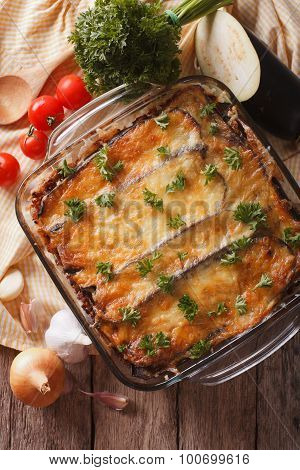 Moussaka Closeup In Baking Dish And Ingredients. Vertical Top View