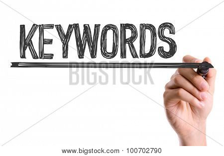 Hand with marker writing the word Keywords