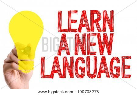 Hand with marker writing the word Learn a New Language